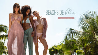 Models wearing blue and pink bikinis and cover ups standing by palm trees. Shop cover ups. 