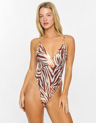 Woman wearing a zebra print swimsuit on a white background