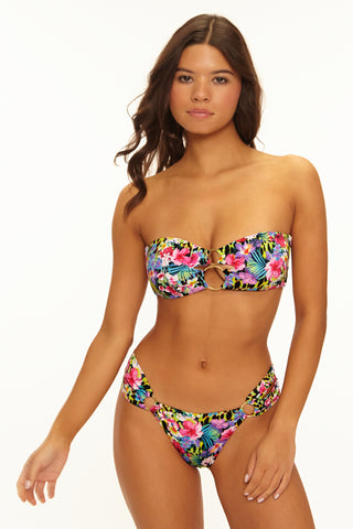 Woman wearing a colorful floral bikini on a white background