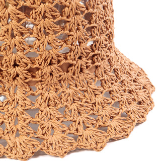 Detail image of a wood tan crochet bucket hat with scalloped brim. 