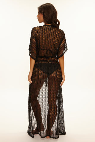 Woman wearing a black crochet cover-up on a white background